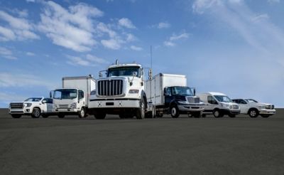 Various types of fleet vehicles sitting next to eachother.