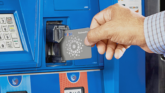 Business owner using a fleet fuel card at a gas pump