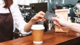 Customer paying with customizable fleet fuel card at coffee shop