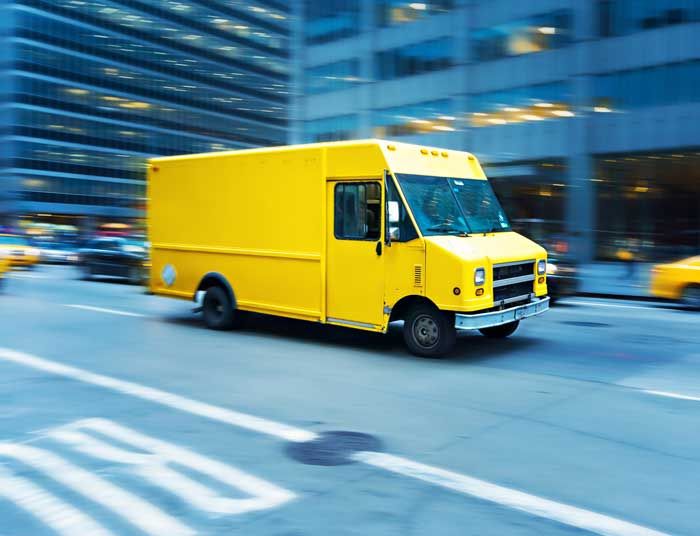 A yellow delivery truck on its route in New York City.
