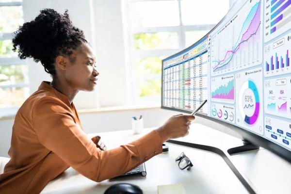 A fleet owner reviews the driver analytics from her ExxonMobil fuel card on her office computer.