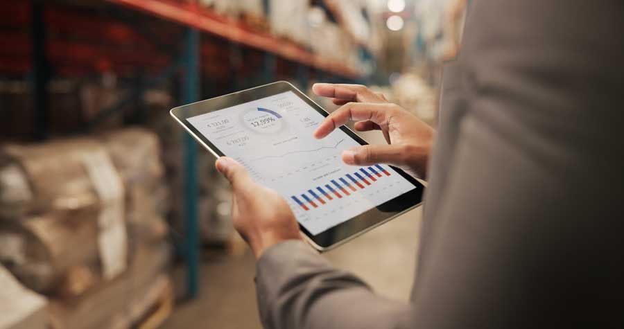 A business owner manages controls of his business fleet fuel cards remotely from a tablet.